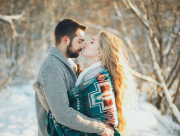 man-and-woman-hugging-each-other-about-to-kiss-during-snow-1927242
