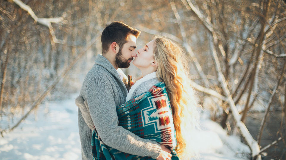 man-and-woman-hugging-each-other-about-to-kiss-during-snow-1927242