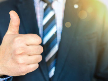 close-up-photo-of-man-wearing-black-suit-jacket-doing-thumbs-684385